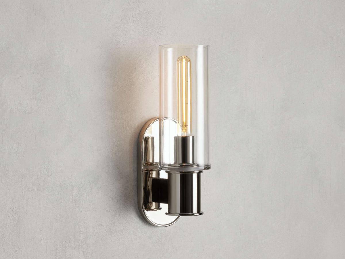 https://cdn.shopify.com/s/files/1/0736/8795/7790/files/harlin-wall-sconce-in-clear-merlin-lamps.jpg?v=1765382025