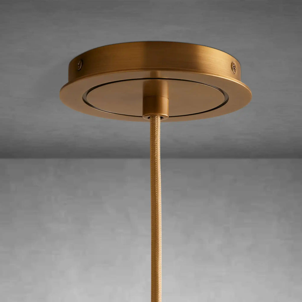 https://cdn.shopify.com/s/files/1/0736/8795/7790/files/matthie-pendant-elegant-brass-finish-pendant-light-merlin-lamps-6.webp?v=1765415197